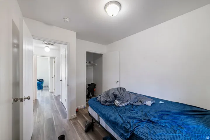 Bedroom with a closet and wood finished floors