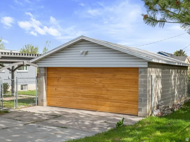 Detached garage with a gate and extra storage space