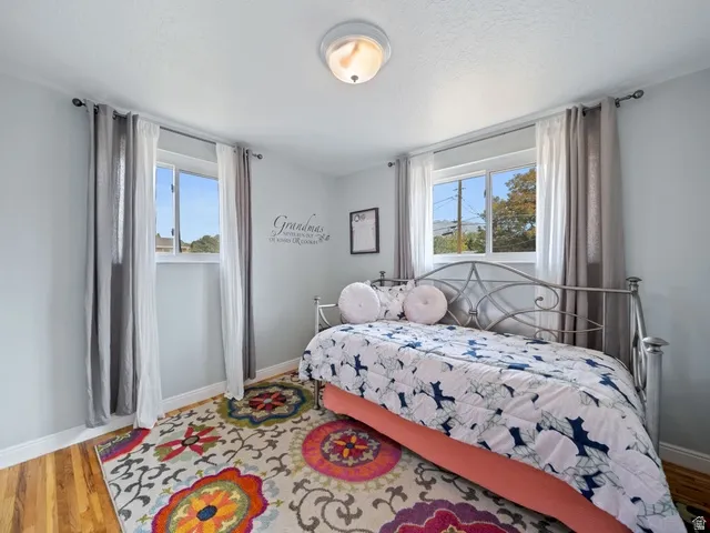 Bedroom #3 featuring light wood-style flooring and baseboards