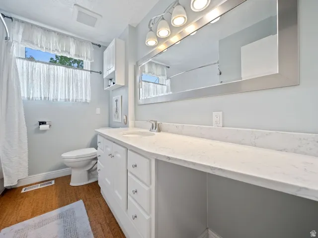 Full bath with vanity, shower/bath combo, and natural light,