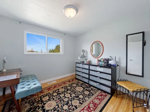 Bedroom #1 featuring light wood-flooring, great natural light and a textured ceiling