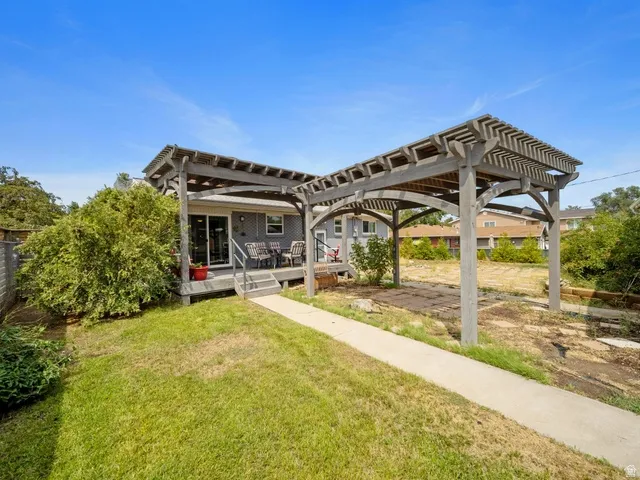 Back of property with a  deck, and pergola for outdoor entertaining