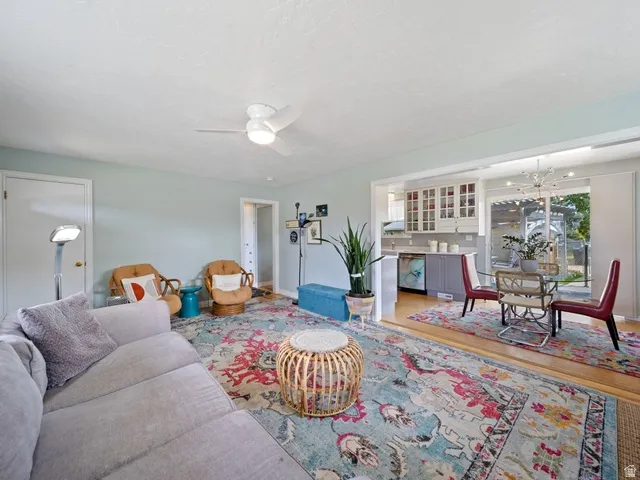 Living area featuring ceiling fan, wood floors