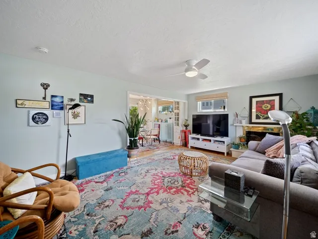Living area with ceiling fan and a textured ceiling