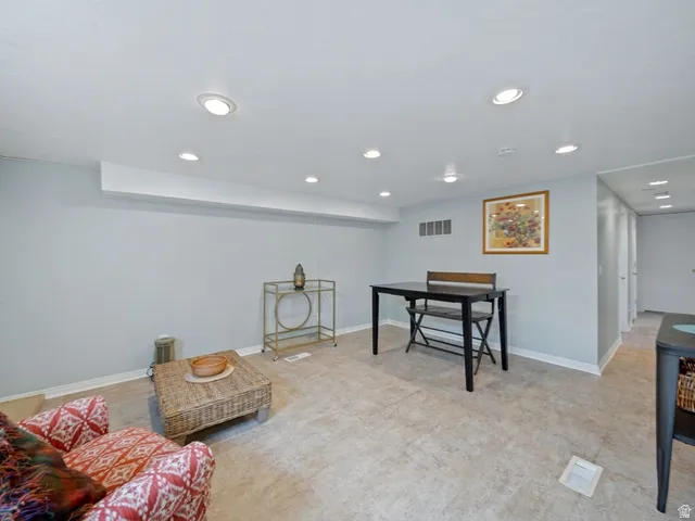 Another view of spacious family room with good natural light and recessed lighting