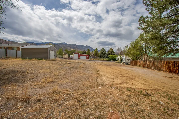 View of yard with an outbuilding, a garage, and a mountain view