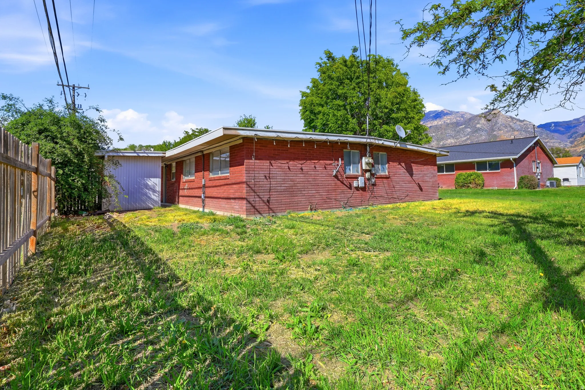 Rear view of house featuring brick siding and a mountain view