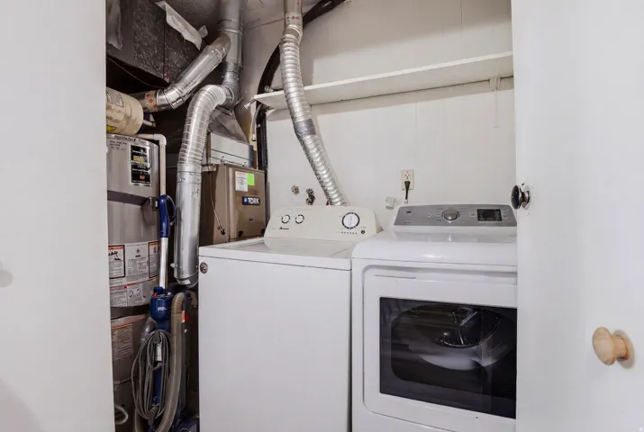 Laundry area featuring water heater and independent washer and dryer