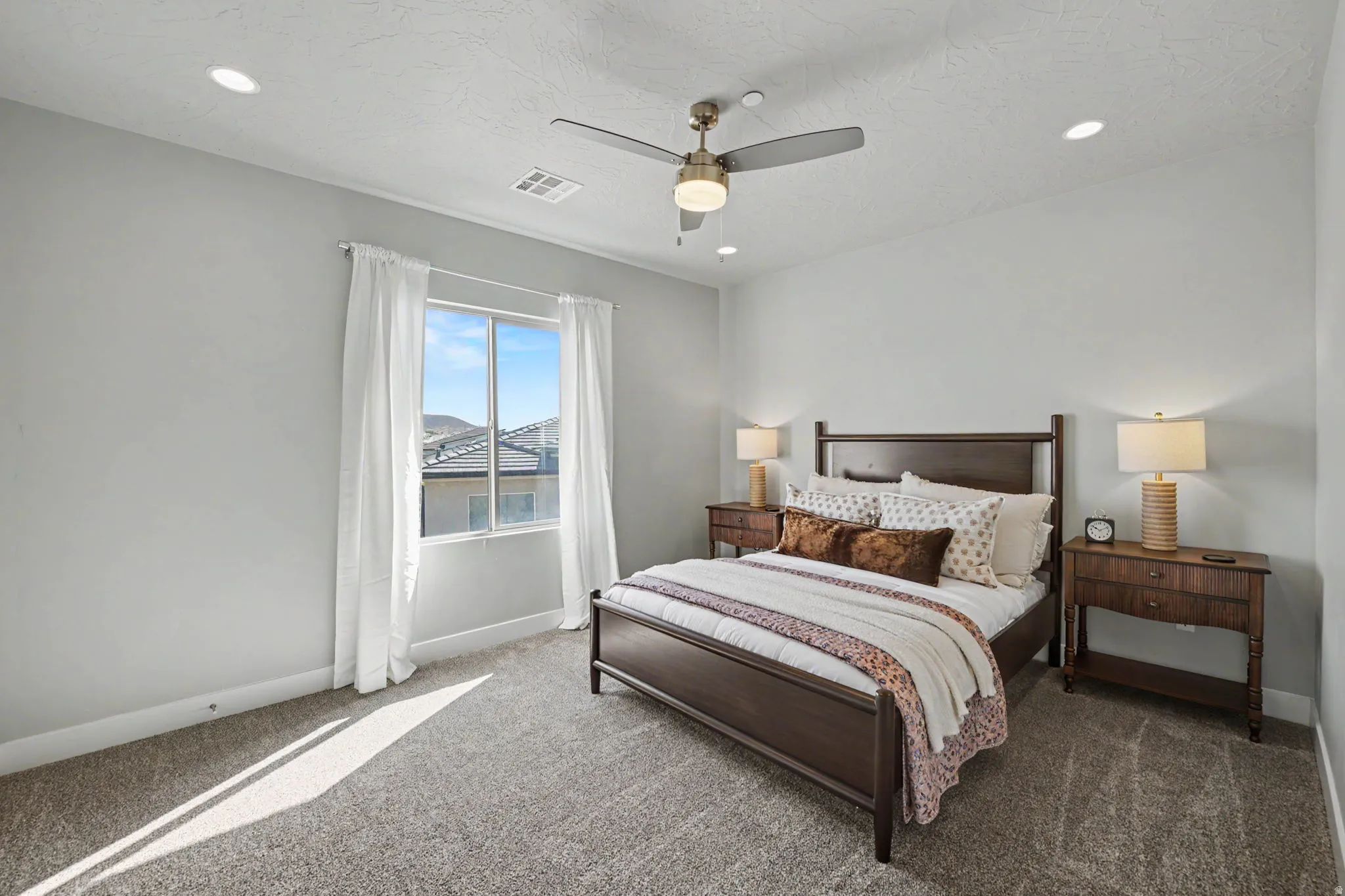 Recessed lighting, ceiling fan, large window, and carpeted flooring