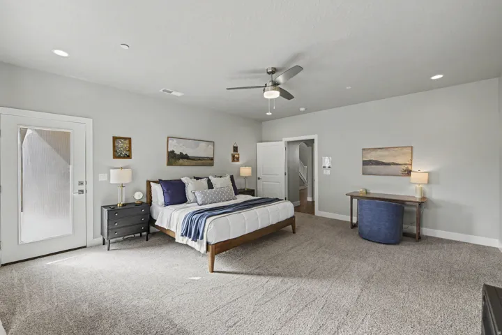 Spacious primary bedroom featuring neutral wall finishes, recessed ceiling lighting, and a ceiling fan
