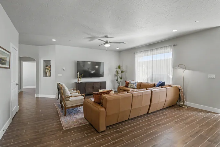 Wood-finish flooring throughout, recessed lighting, and a ceiling fan