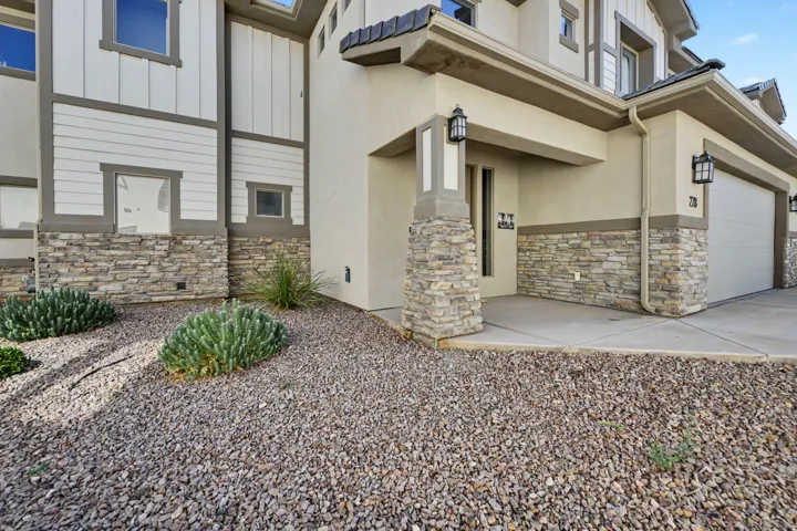 Stucco and stone veneer exterior with a covered entry