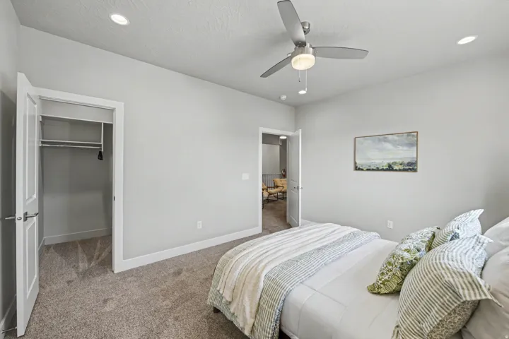 Plush carpet flooring, recessed lighting, and a modern ceiling fan