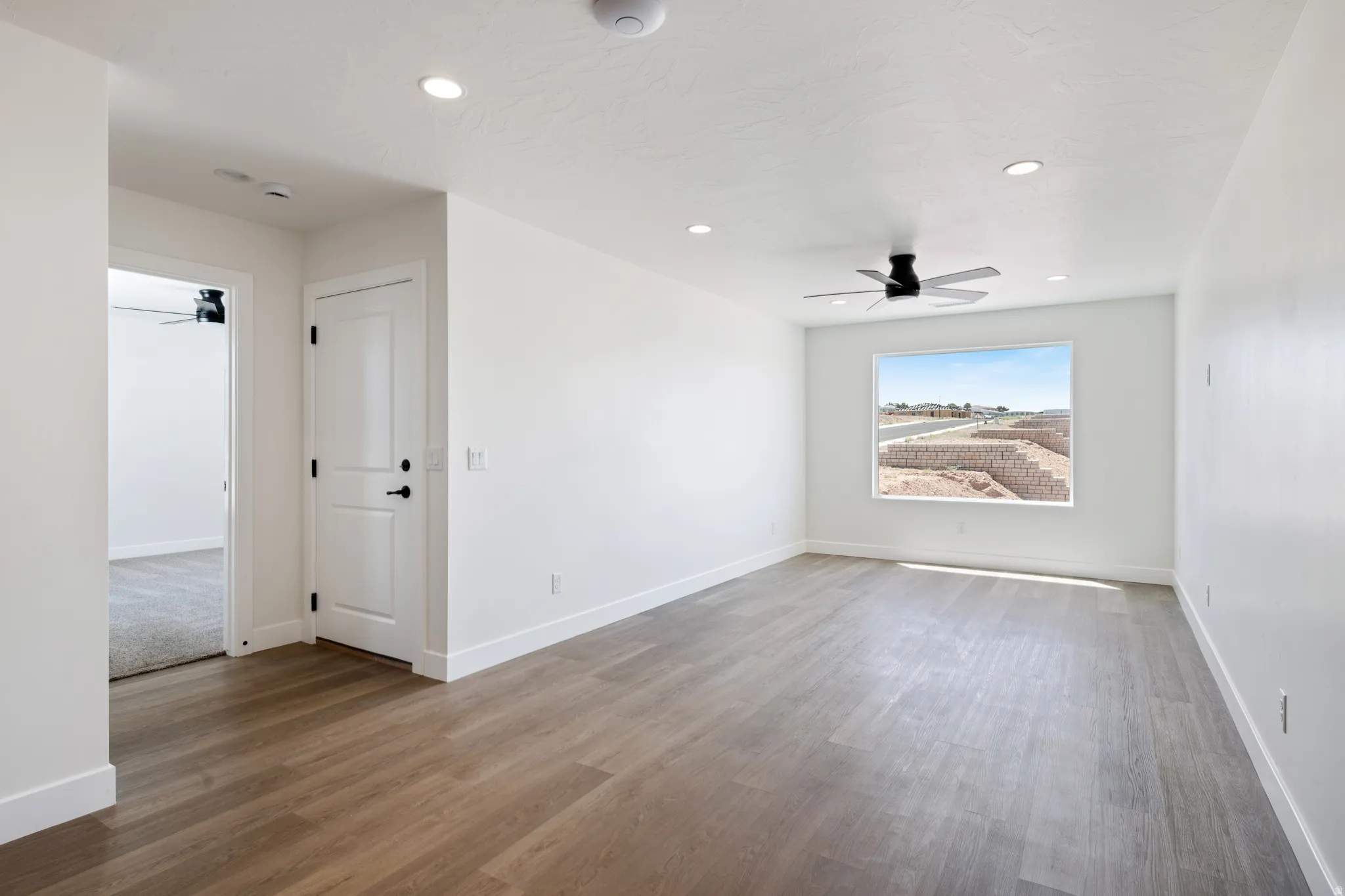 Spare room with ceiling fan, wood finished floors, and recessed lighting