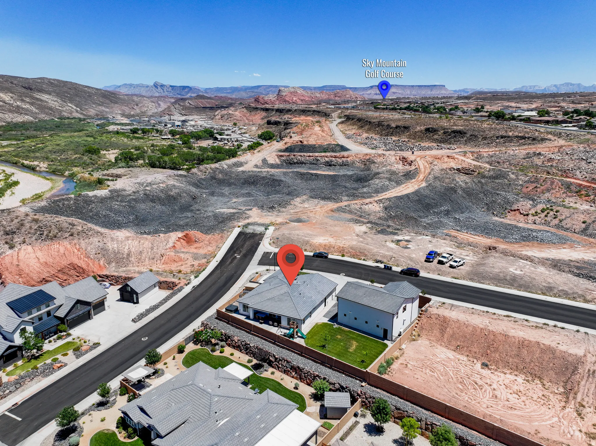 Aerial view of property's location with mountains and nearby suburban area