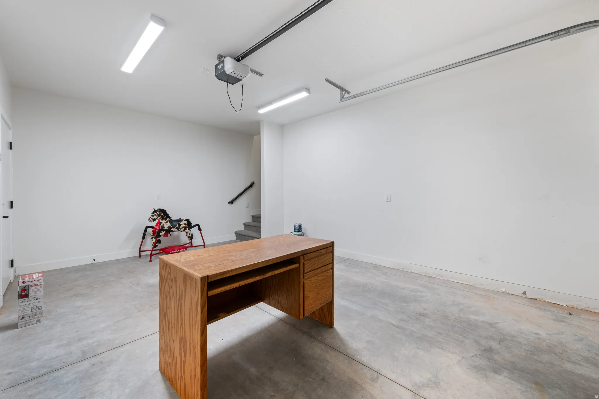 Unfurnished office with concrete flooring and a garage
