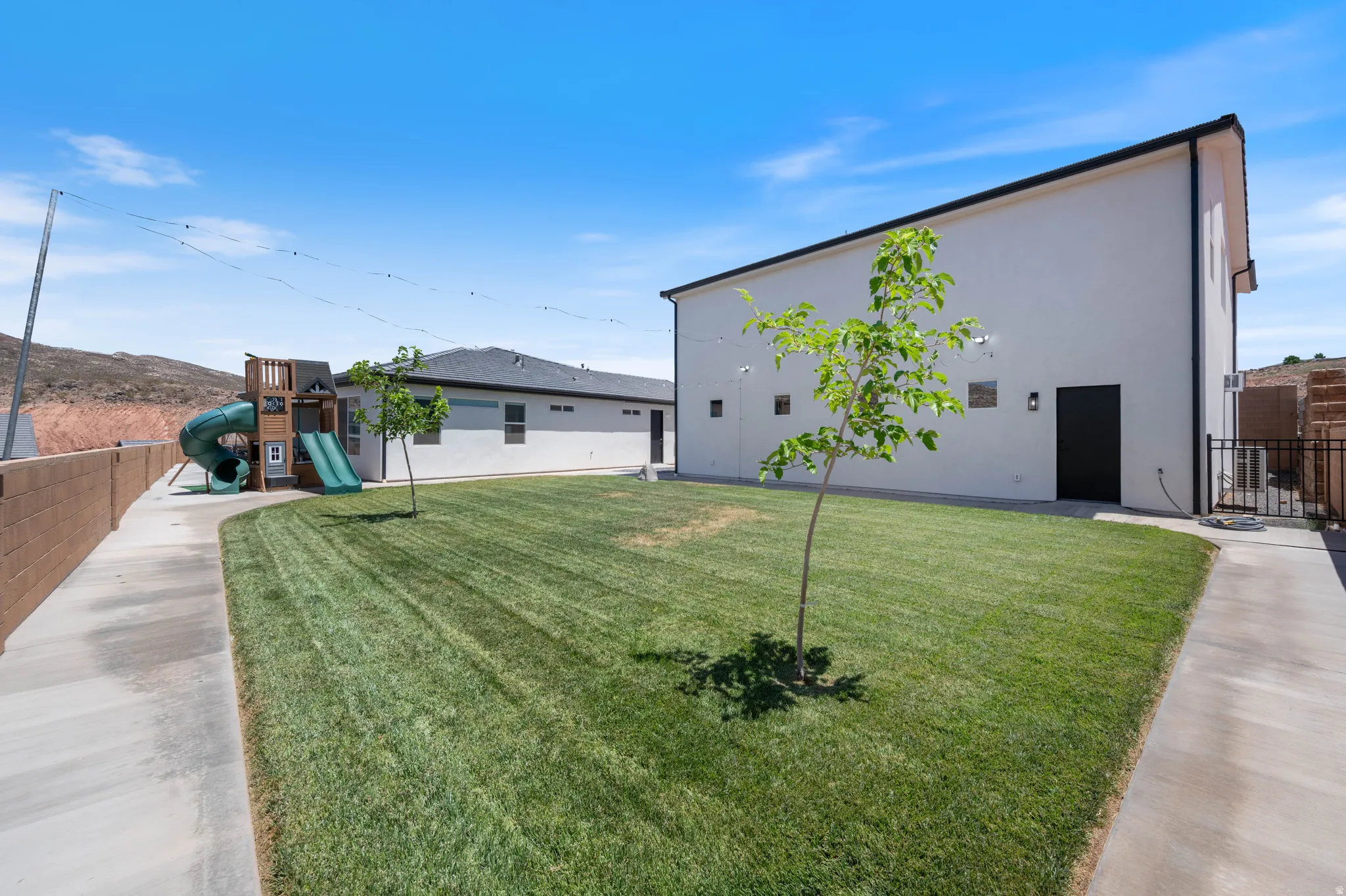 View of home's exterior with a playground and stucco siding