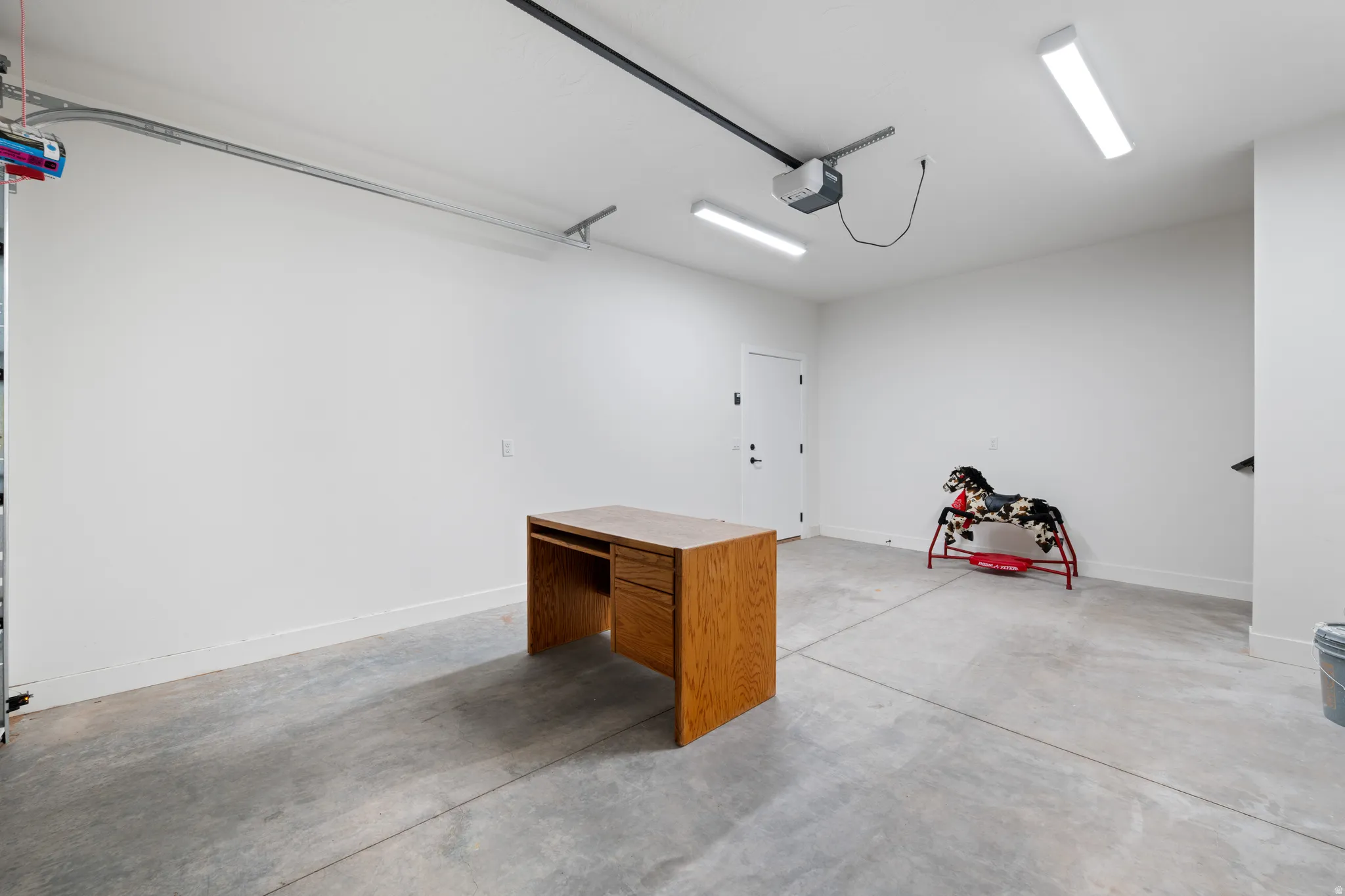 Garage featuring baseboards