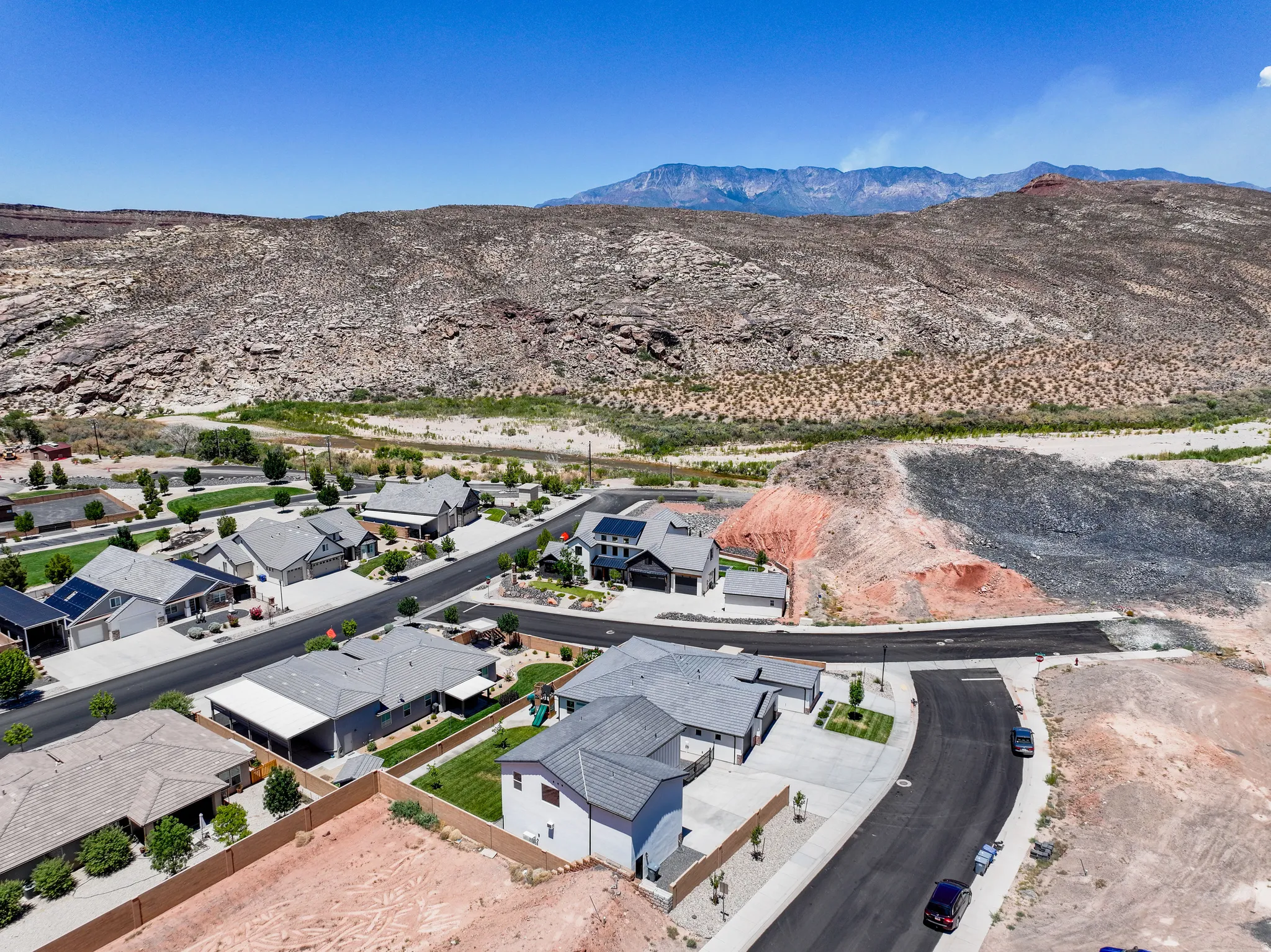 Aerial perspective of suburban area featuring a mountainous background