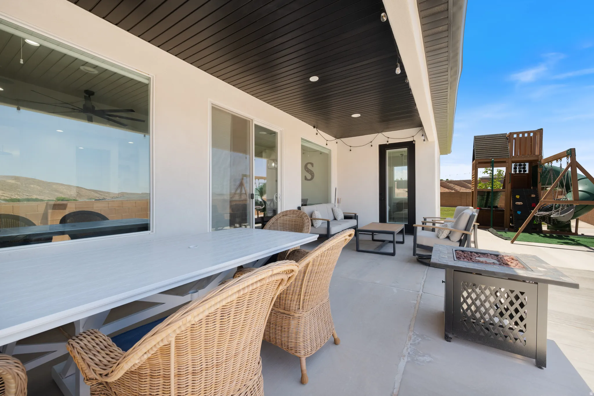 View of patio featuring a playground, outdoor lounge area, and an outdoor fire pit