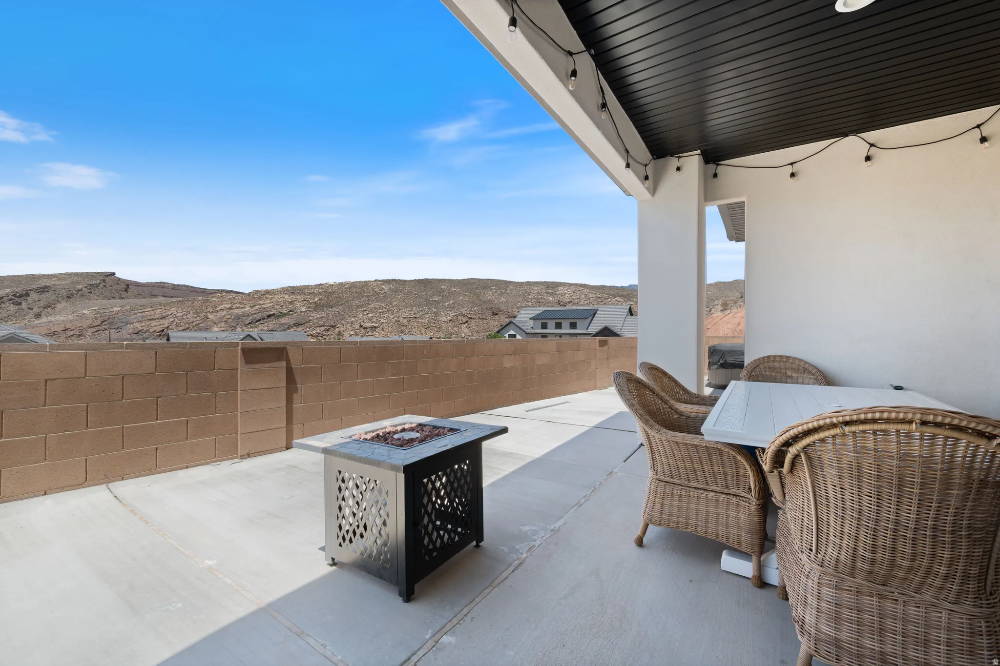 View of patio featuring an outdoor fire pit, a mountain view, and outdoor dining space