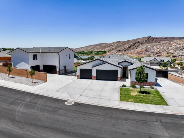 Modern inspired farmhouse with concrete driveway, a mountain view, and an attached garage