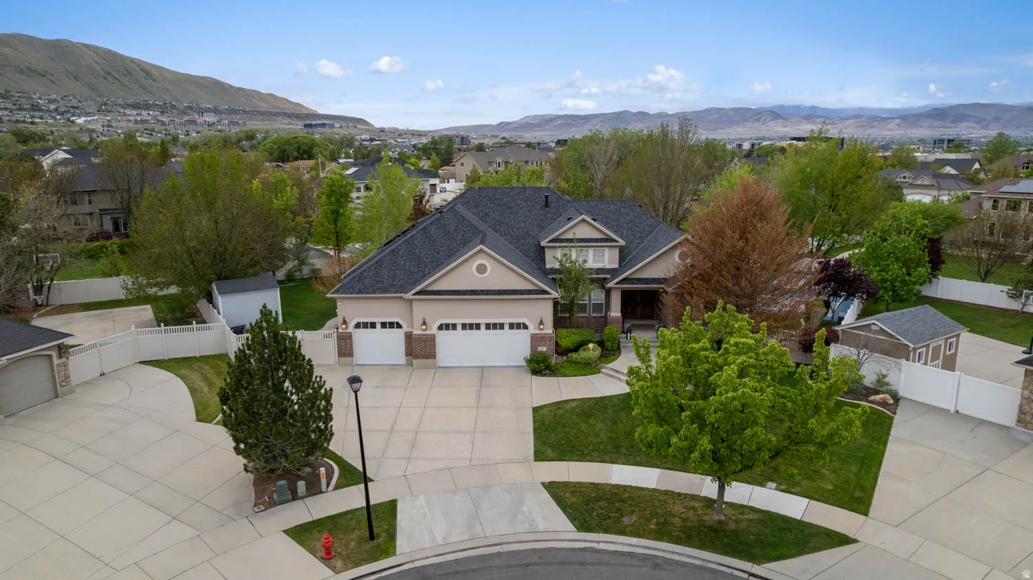 View of front facade featuring a mountain view, concrete driveway, and an attached garage