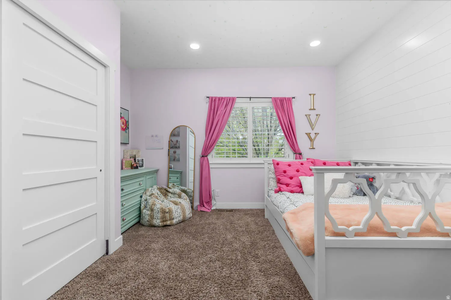 Bedroom with dark colored carpet and recessed lighting