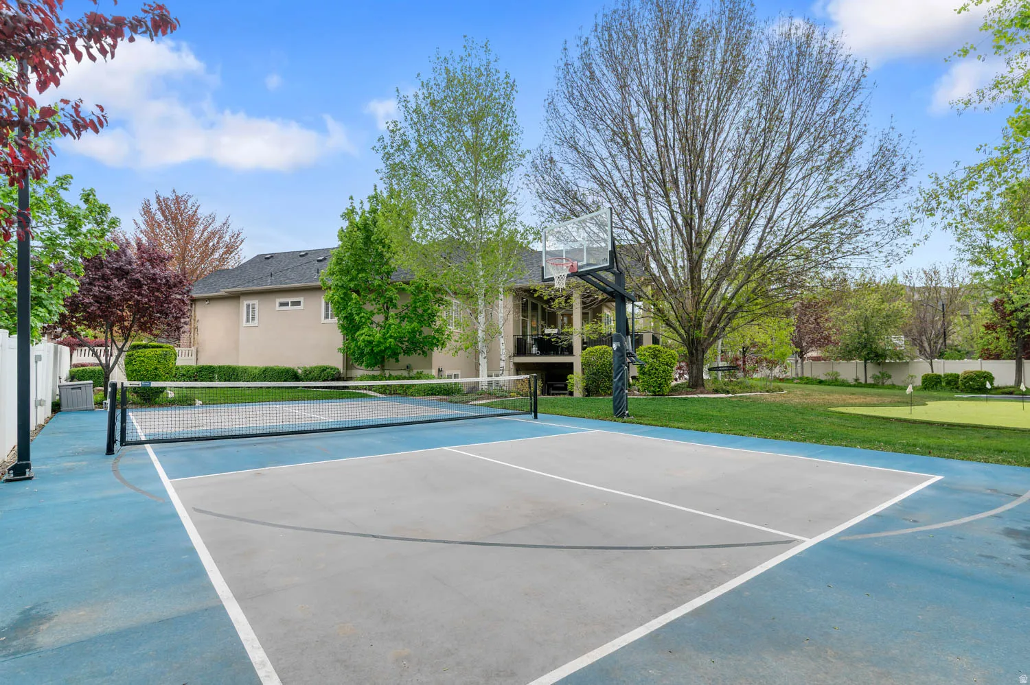 View of a Pickleball court/basketball court, and a putting area