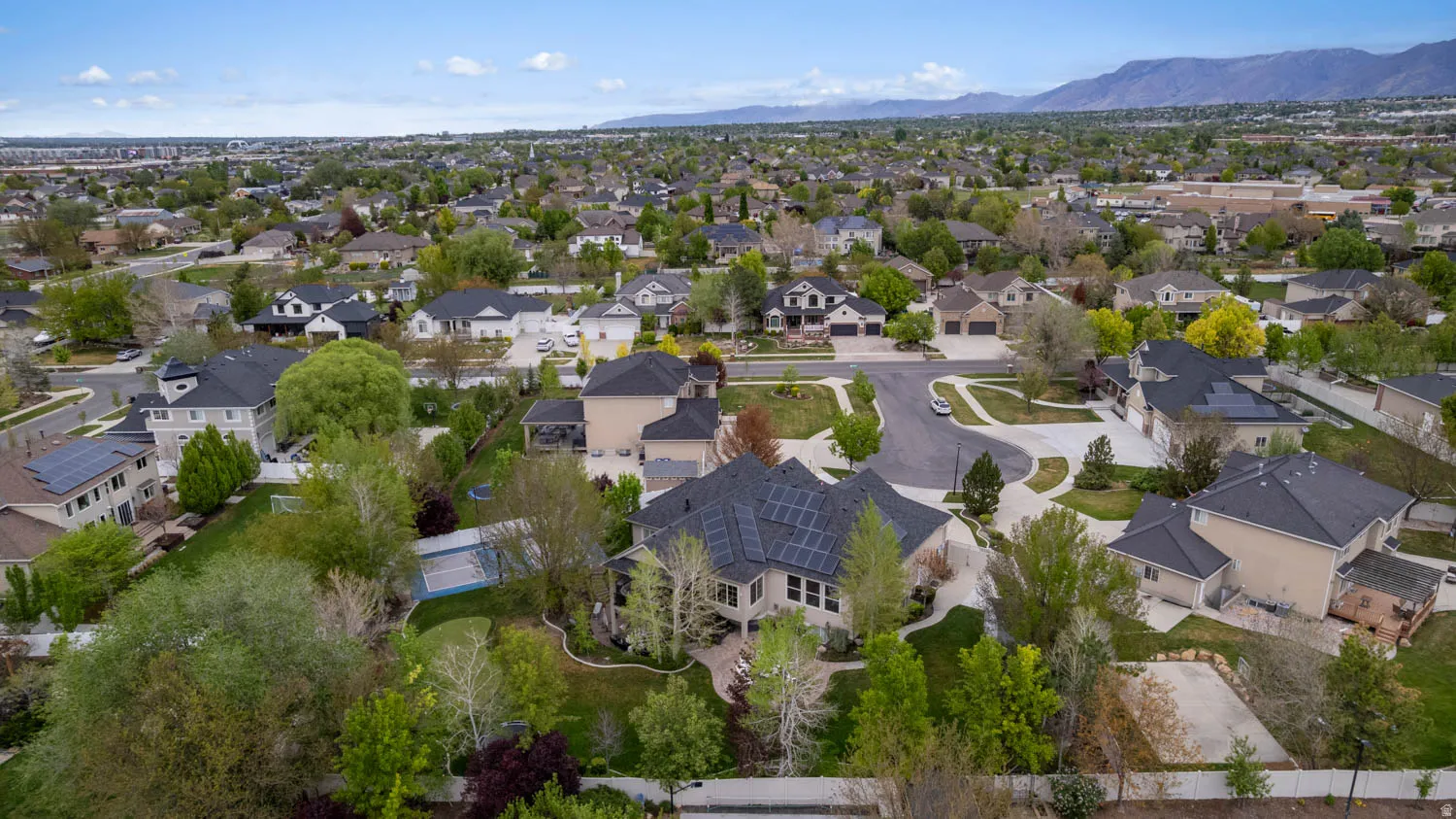 Aerial perspective of suburban area featuring a mountain backdrop