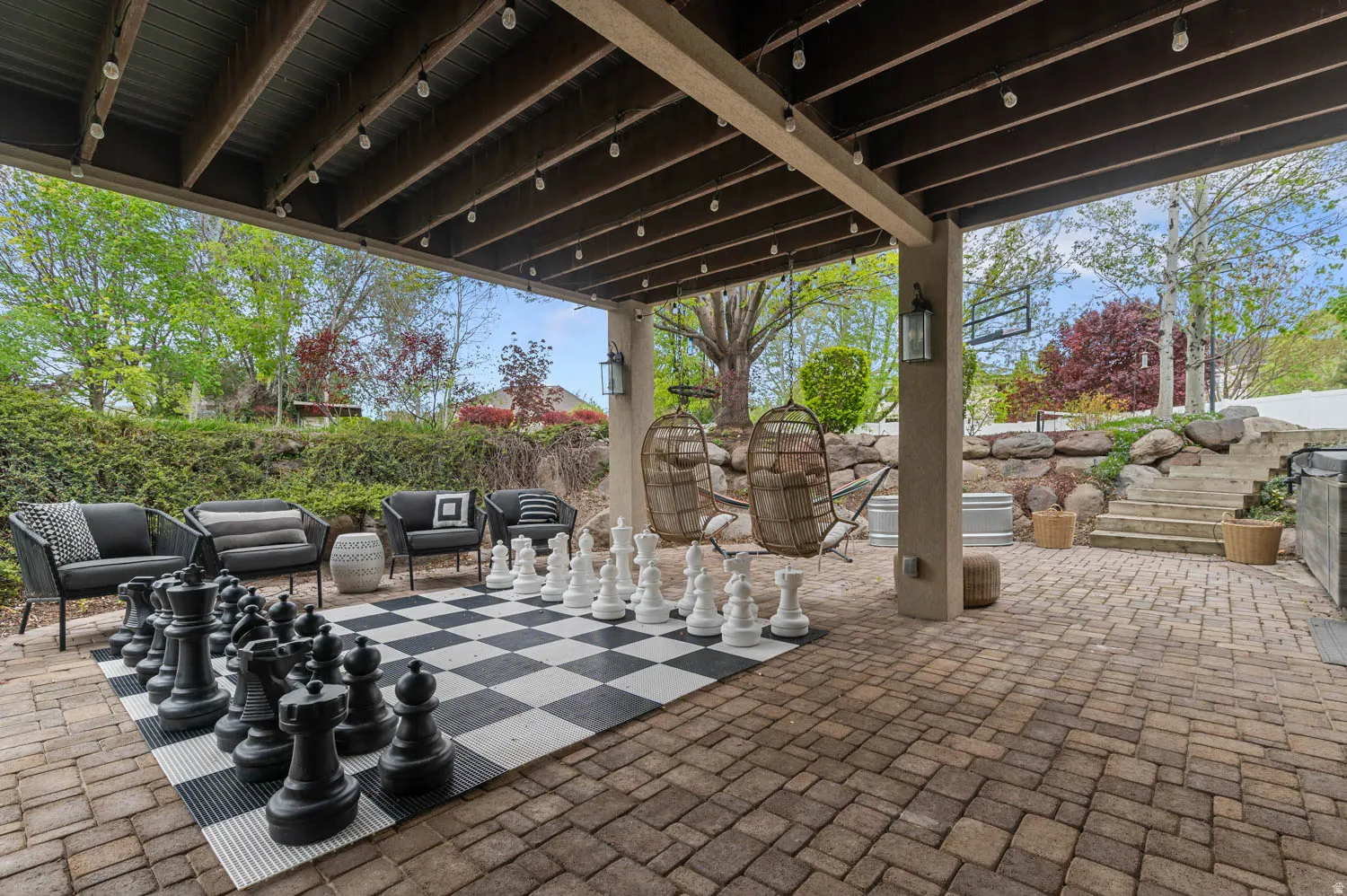 Fenced backyard featuring a patio area and an outdoor lounge area