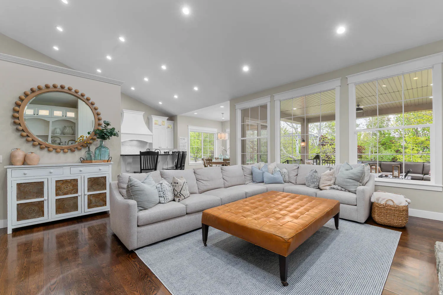 Living area with lofted ceiling, recessed lighting, and dark wood finished floors