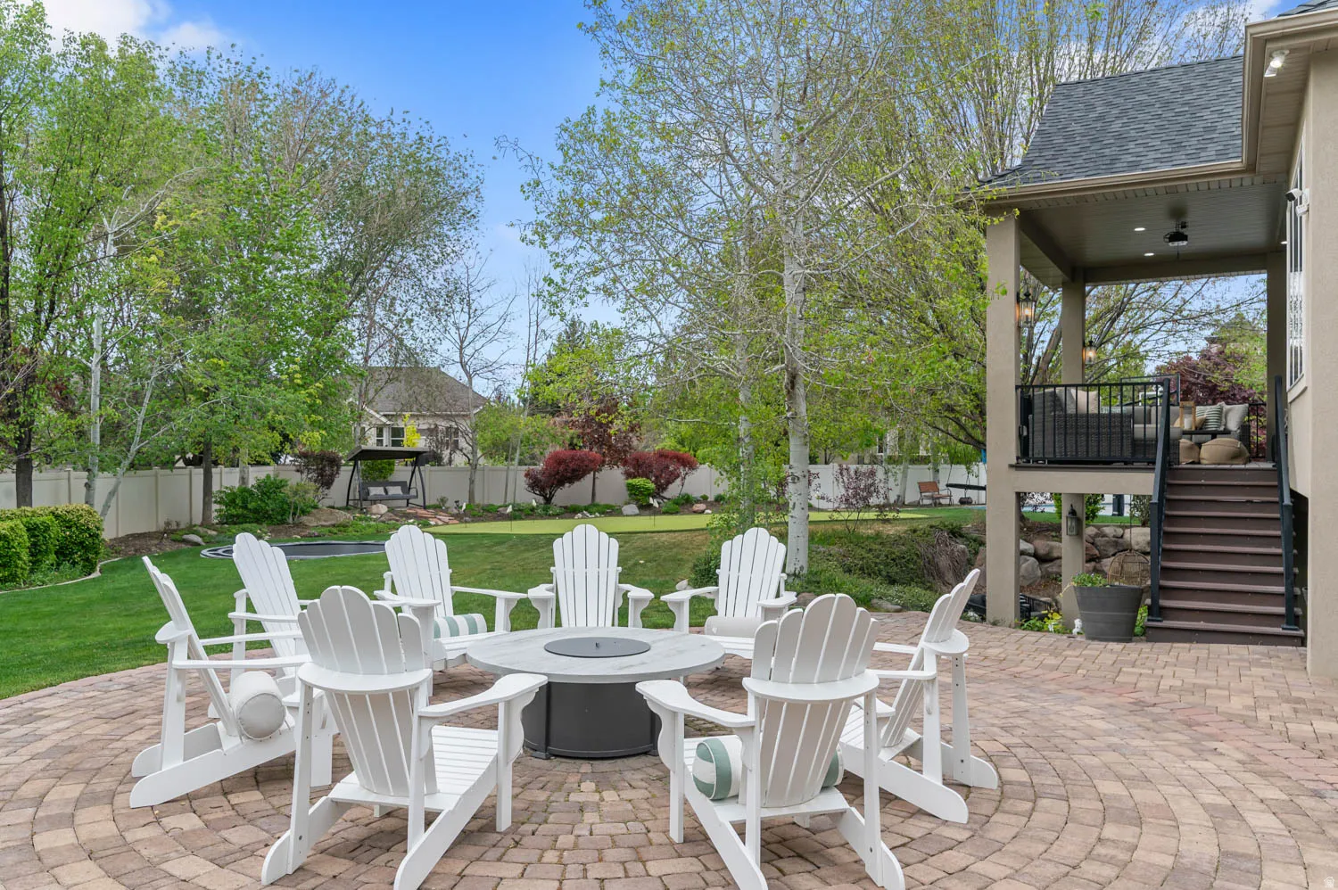 Fenced backyard featuring a patio area and a fire pit
