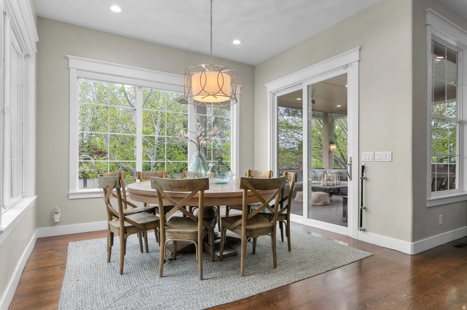 Dining space featuring dark wood-style flooring, plenty of natural light, and recessed lighting