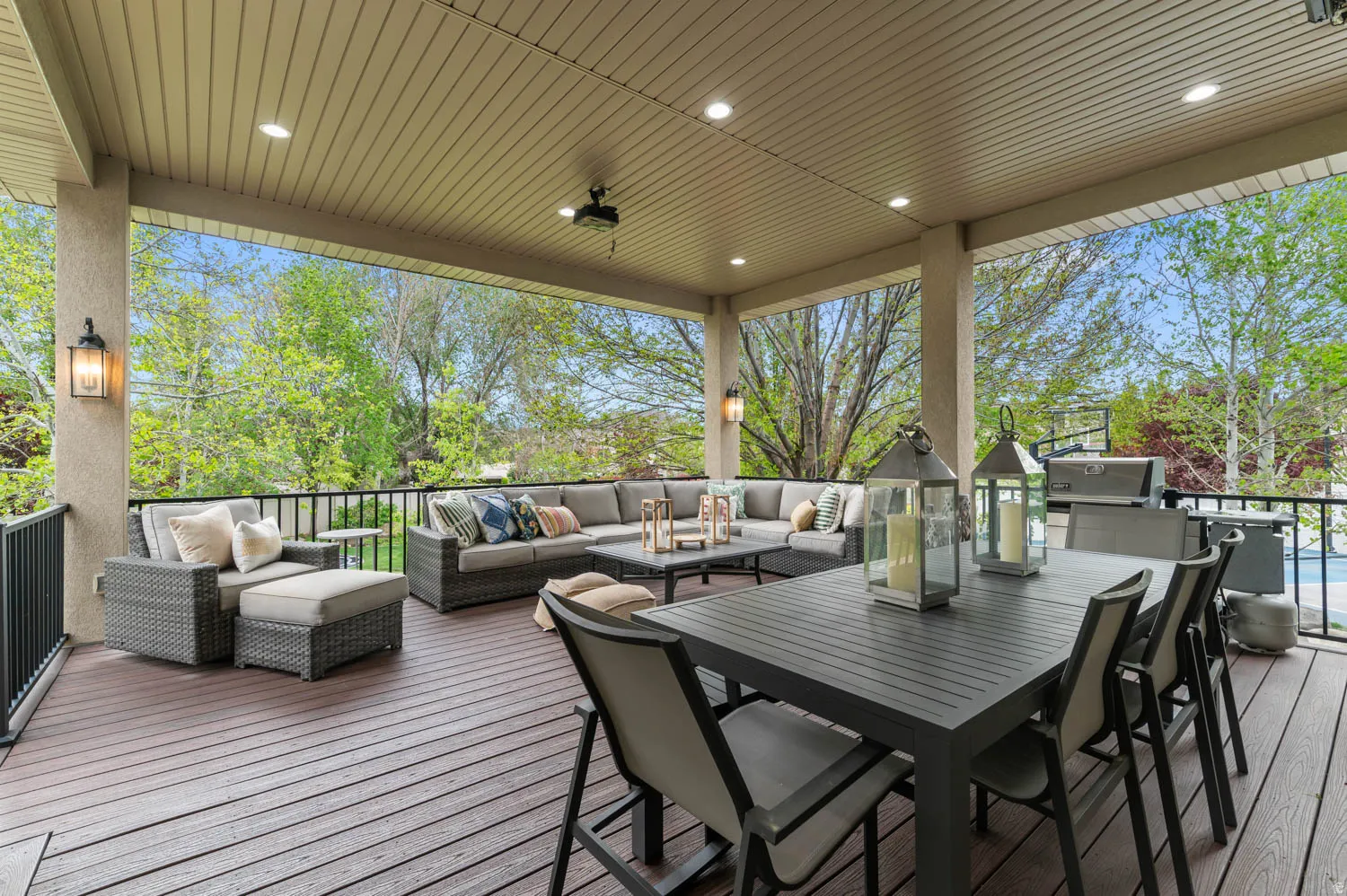 Deck with an outdoor living / dining area