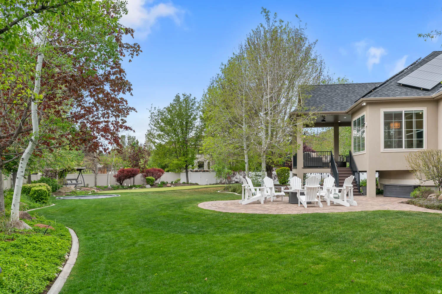 Fenced yard with a patio and a deck