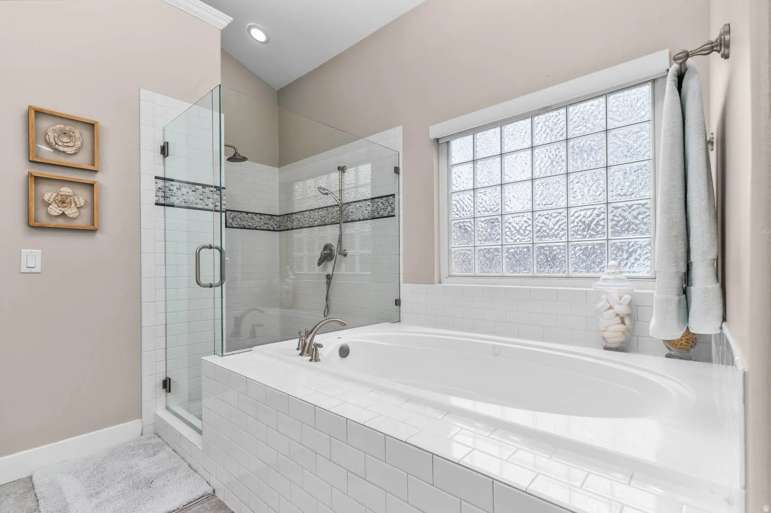 Bathroom featuring a shower stall and a bath