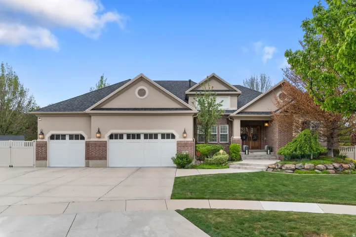 Craftsman-style home featuring an attached garage, stucco siding, and concrete driveway