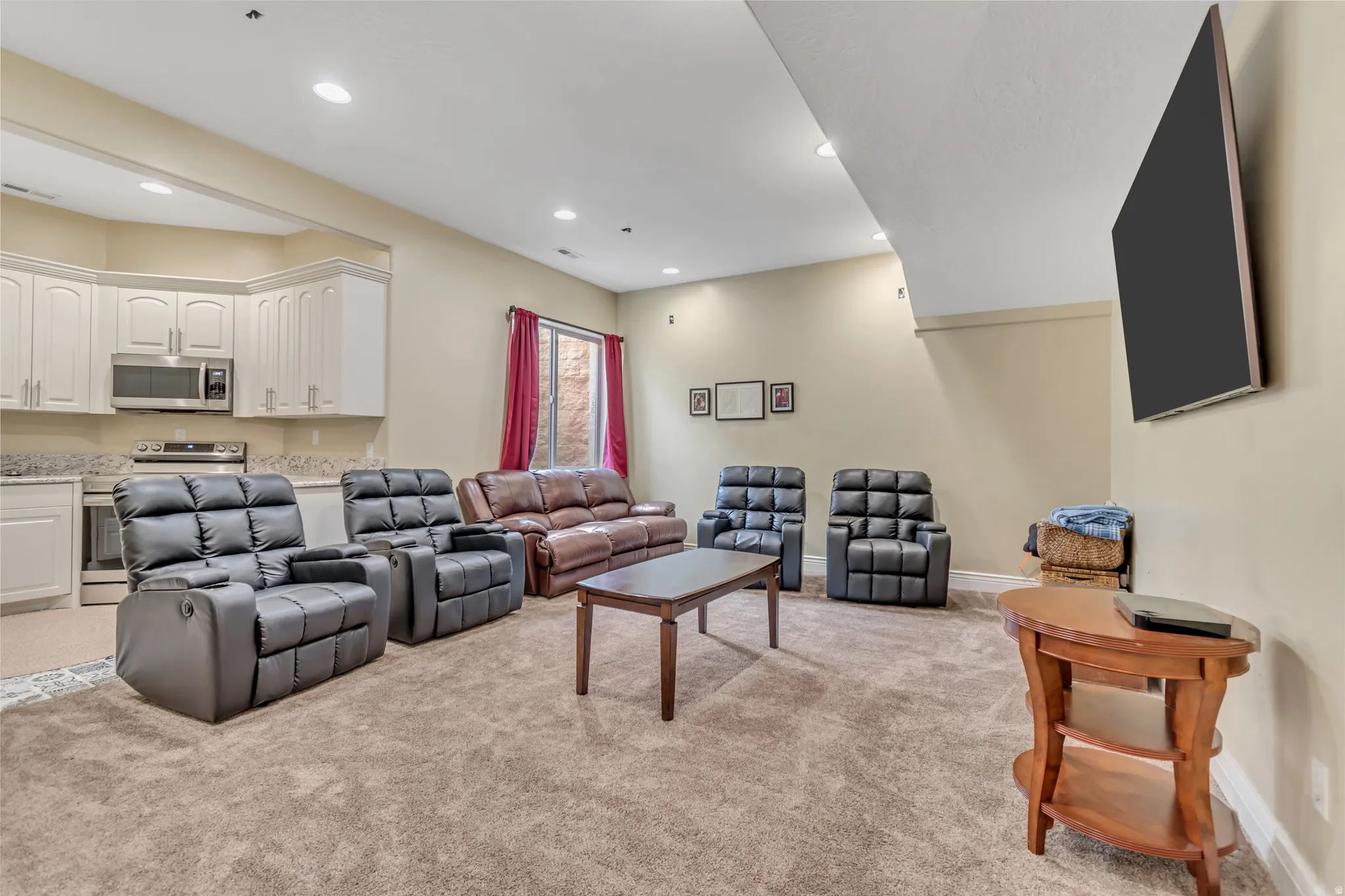 Living room featuring light colored carpet and recessed lighting