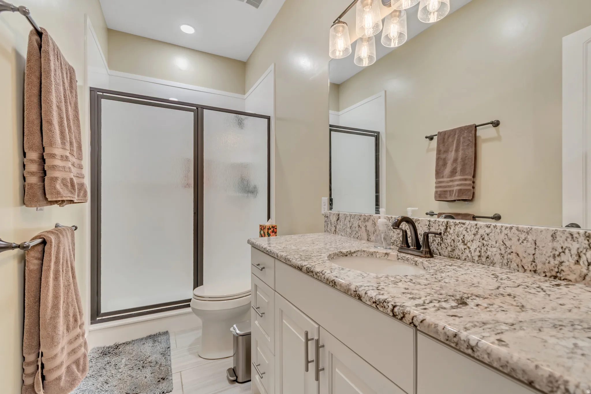 Bathroom featuring vanity, a stall shower, and recessed lighting