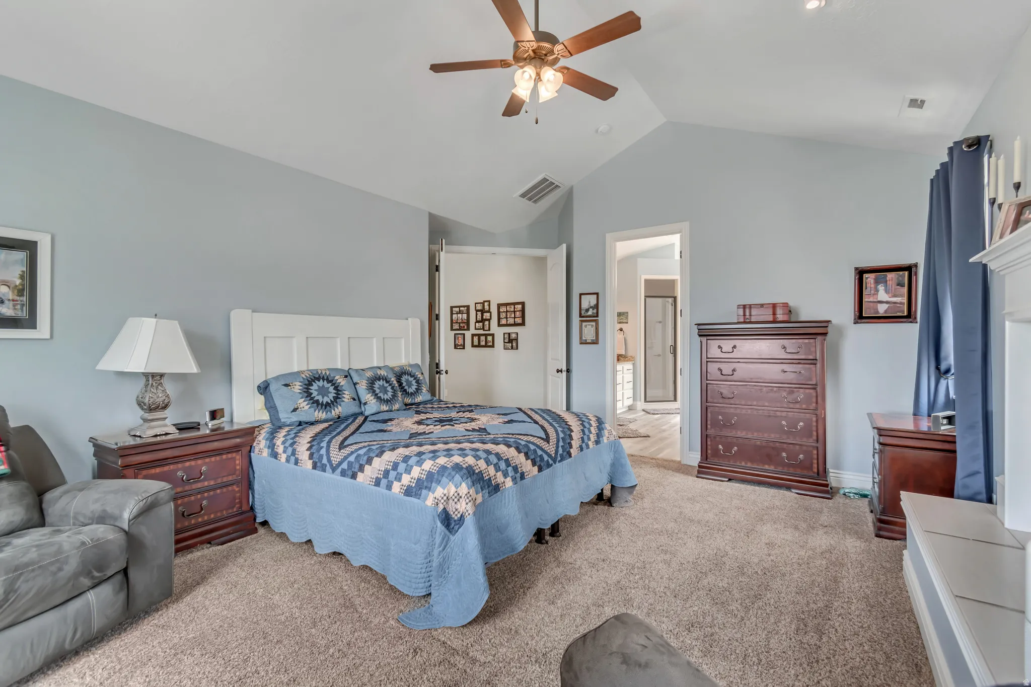 Carpeted bedroom with a ceiling fan