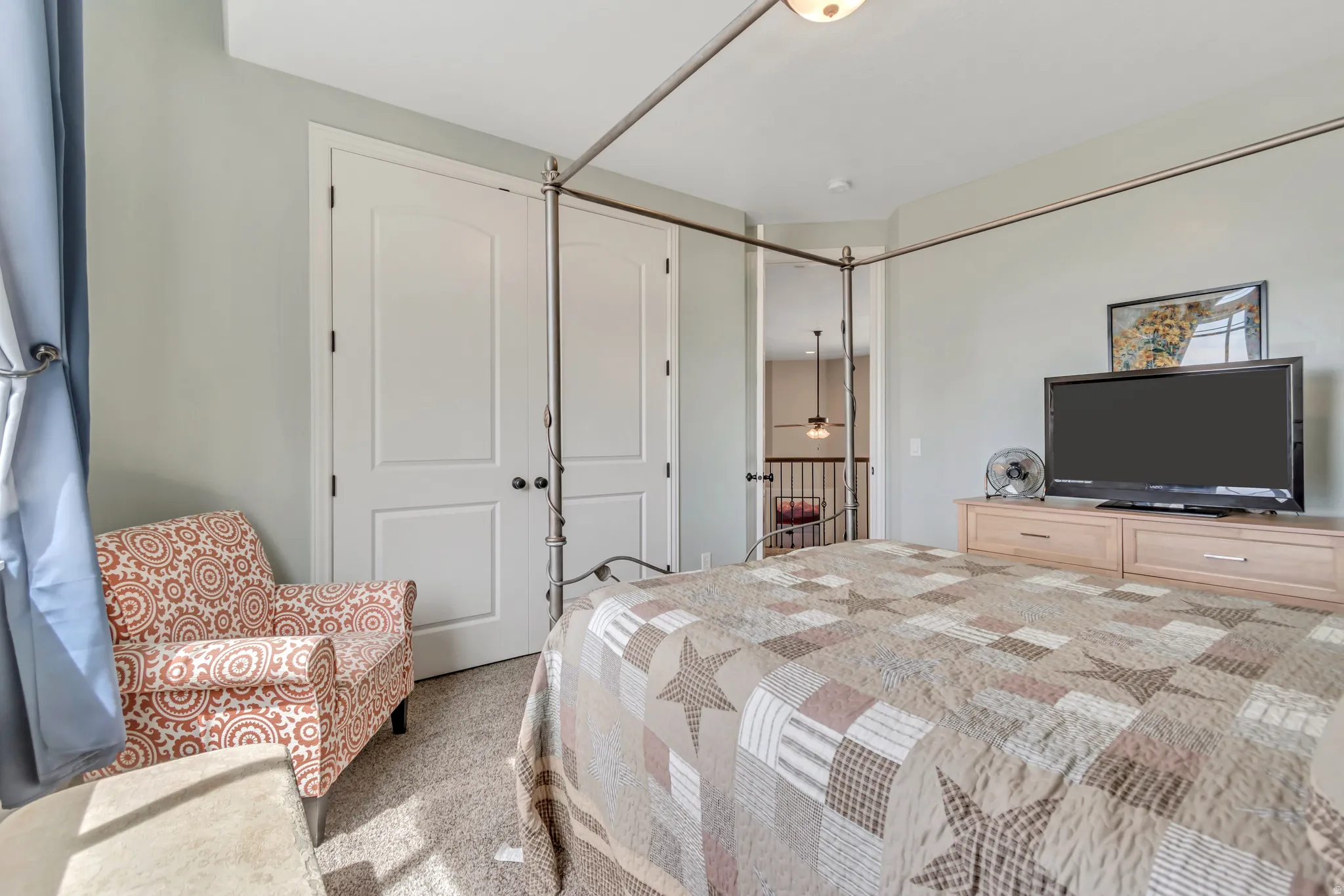 Carpeted bedroom with a closet