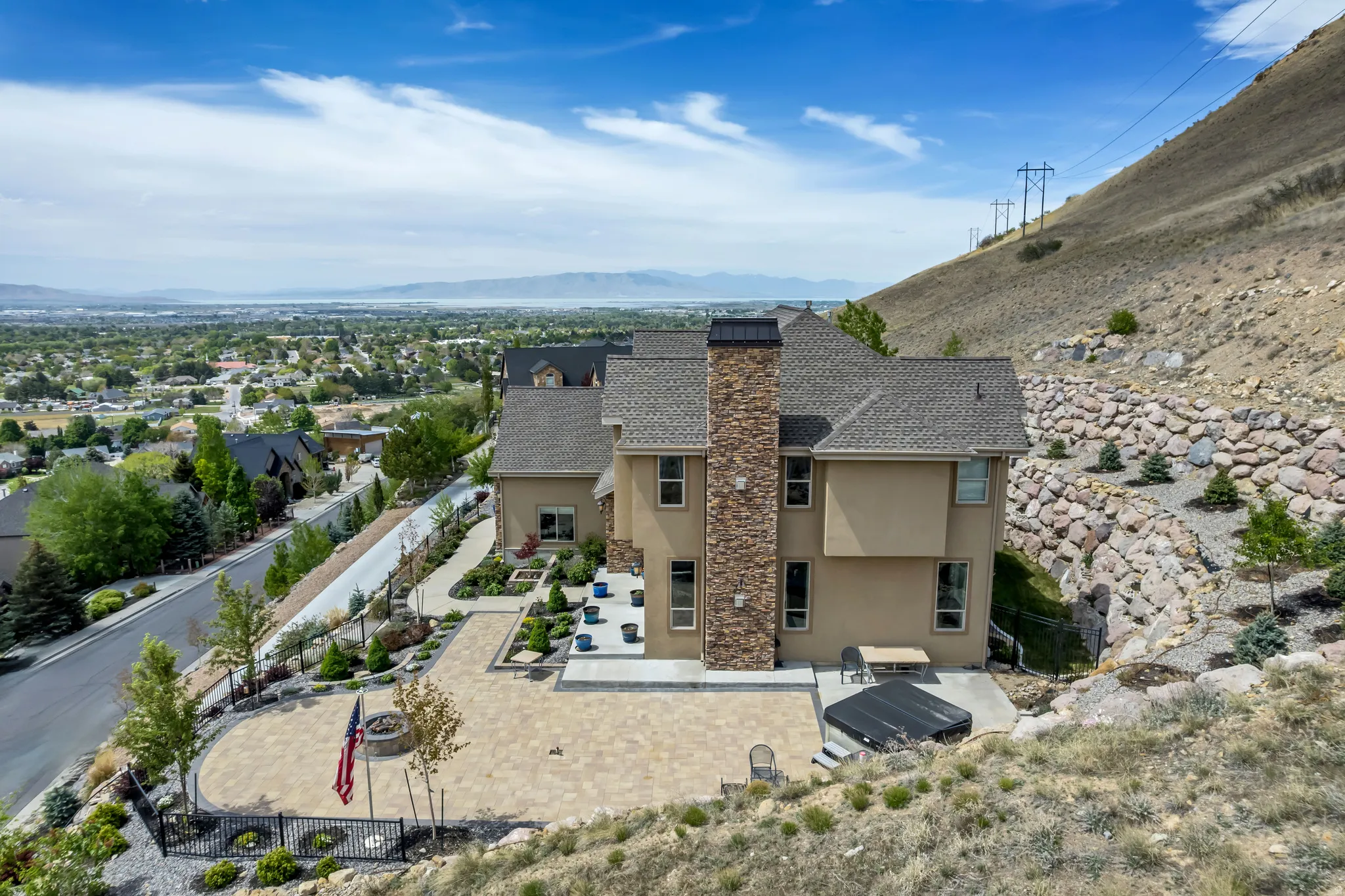 Rear view of property with stucco siding, a mountain view, a patio area, and a fenced backyard