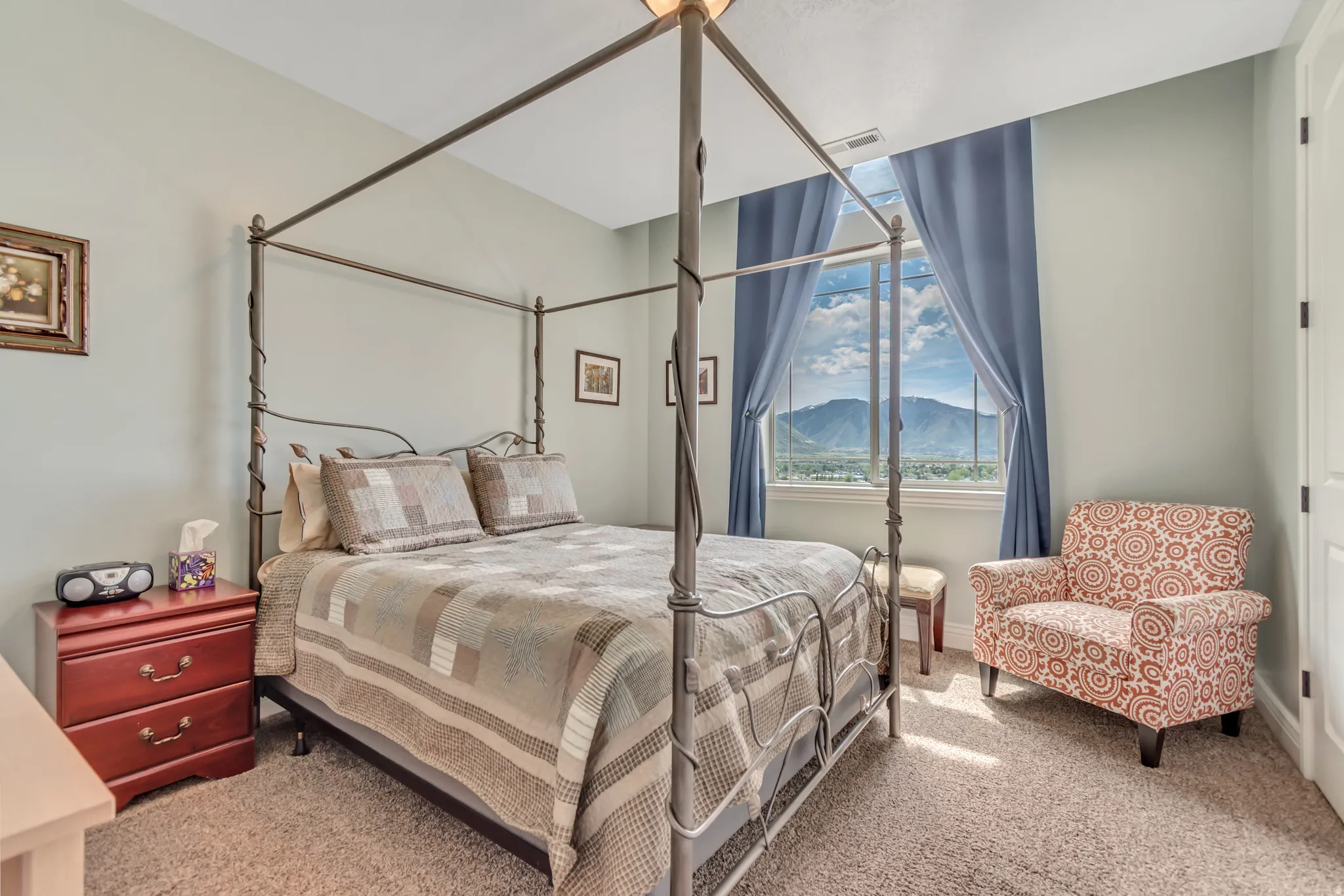 Bedroom featuring light colored carpet and a mountain view