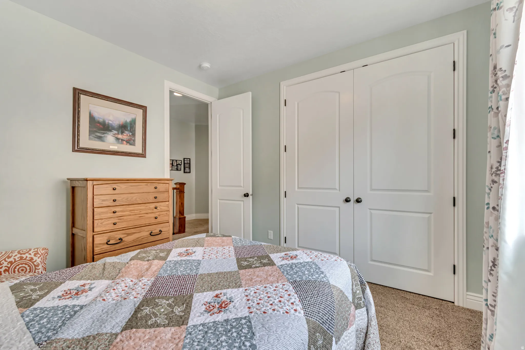Bedroom featuring a closet and light colored carpet