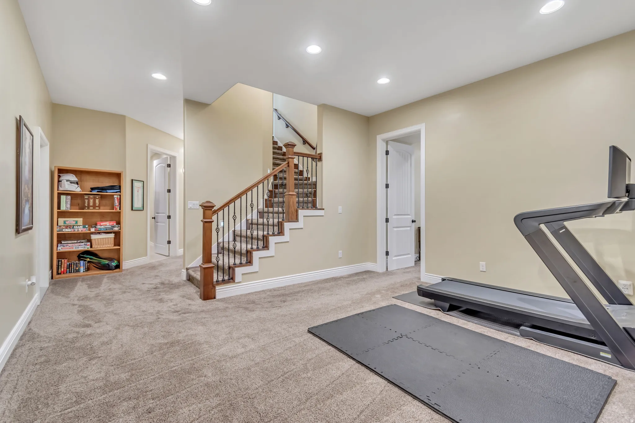 Exercise room featuring light colored carpet and recessed lighting