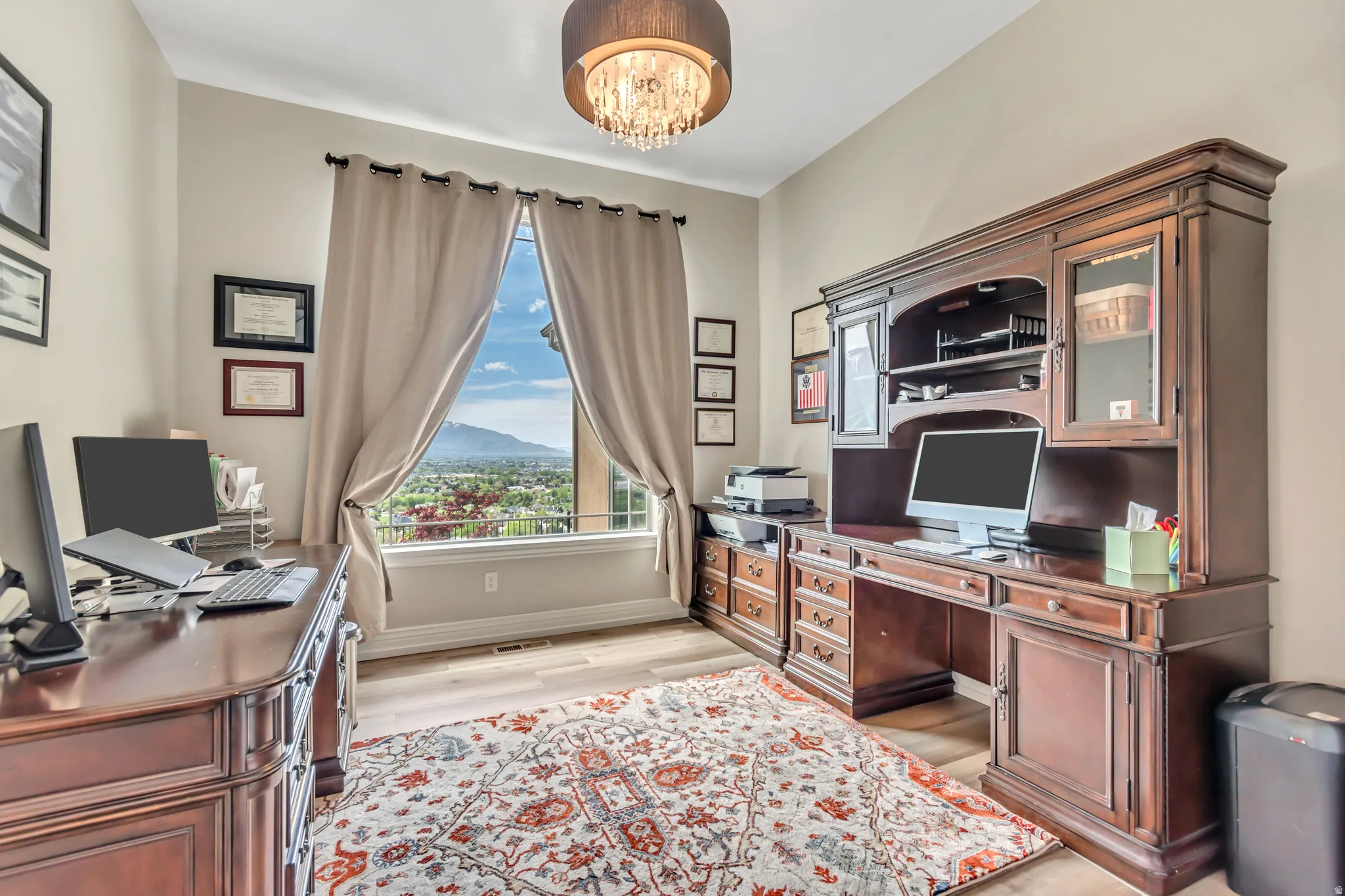 Office space featuring light wood-style floors and a chandelier
