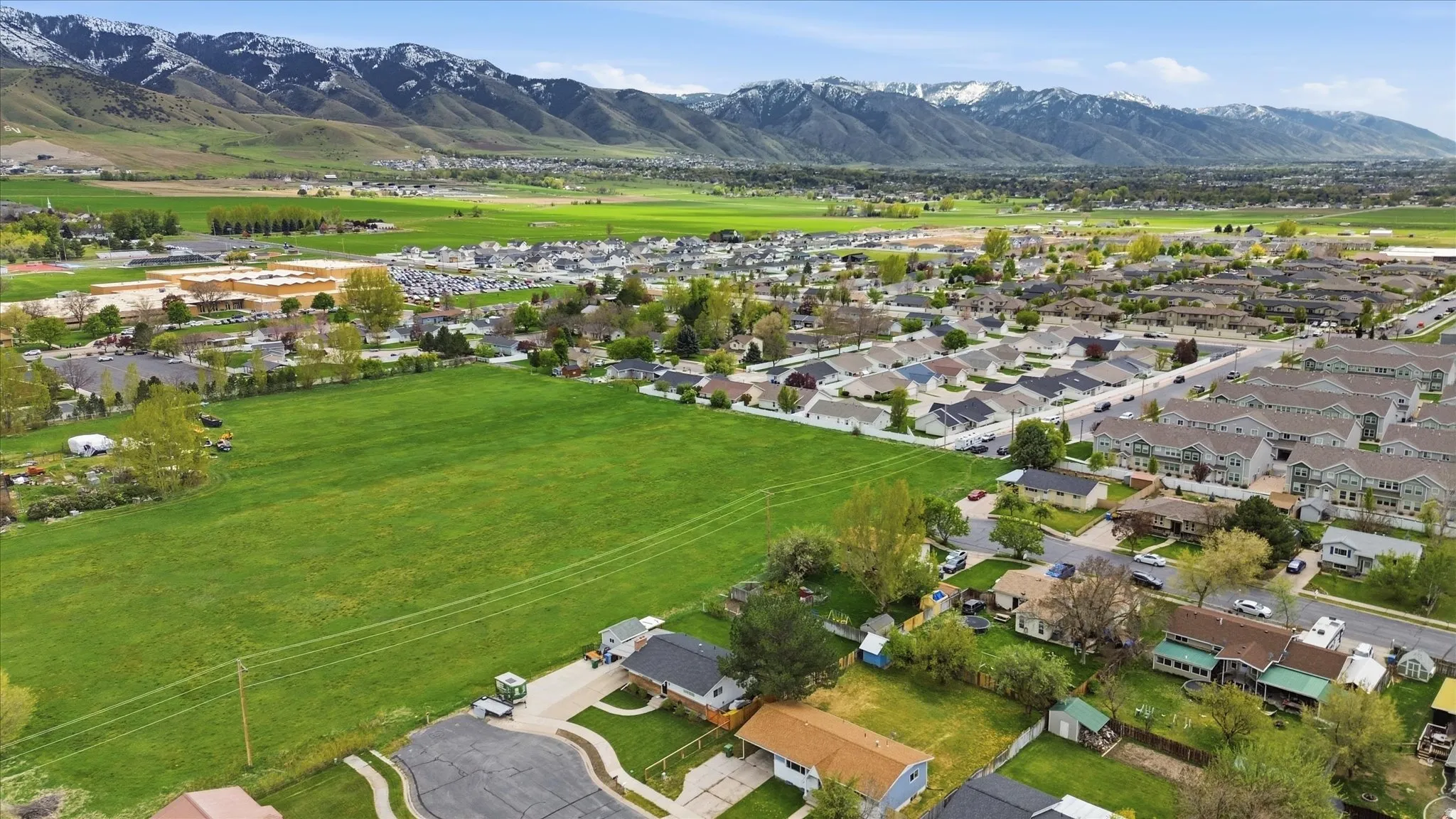 Aerial perspective of suburban area with a mountainous background