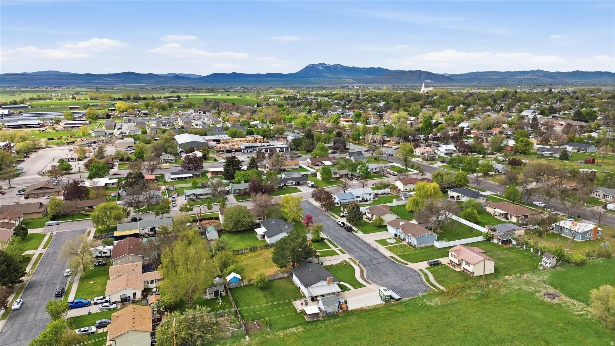 Aerial perspective of suburban area with a mountainous background