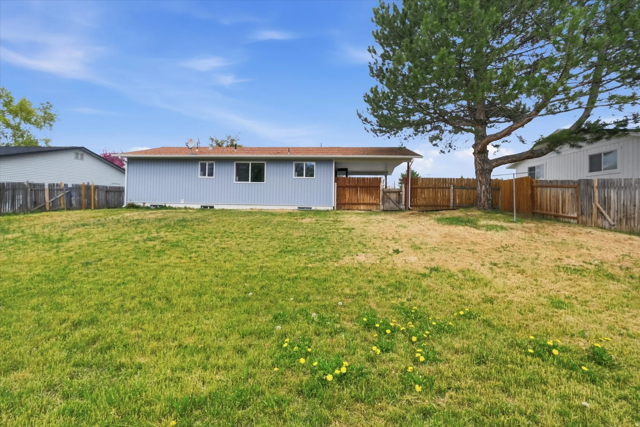 Rear view of house featuring crawl space and a fenced backyard